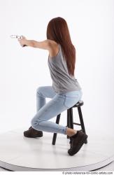 Woman Adult Athletic White Fighting without gun Sitting poses Casual